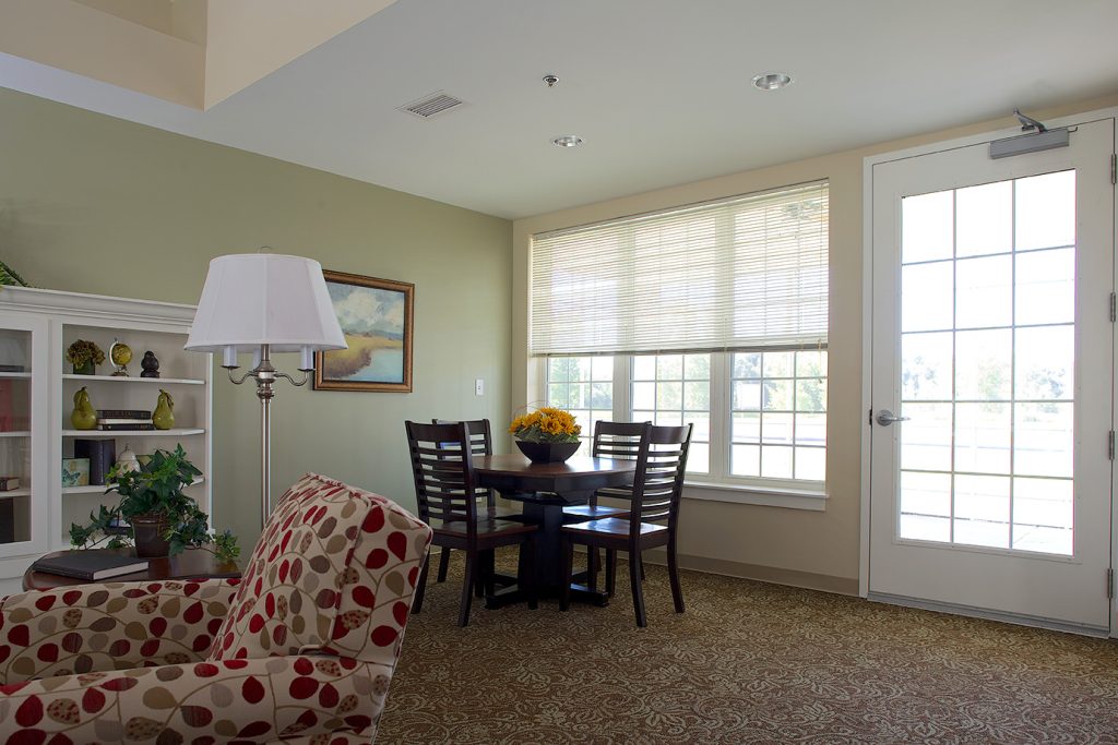 A sitting area with armchairs beside French doors