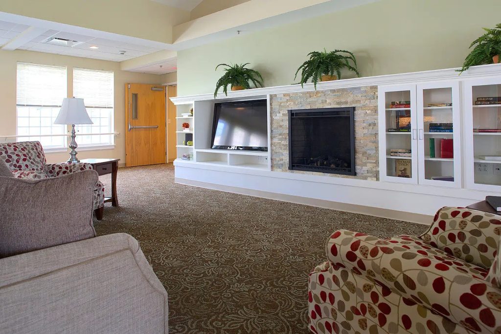 The hearth room with a fireplace and built-in shelves