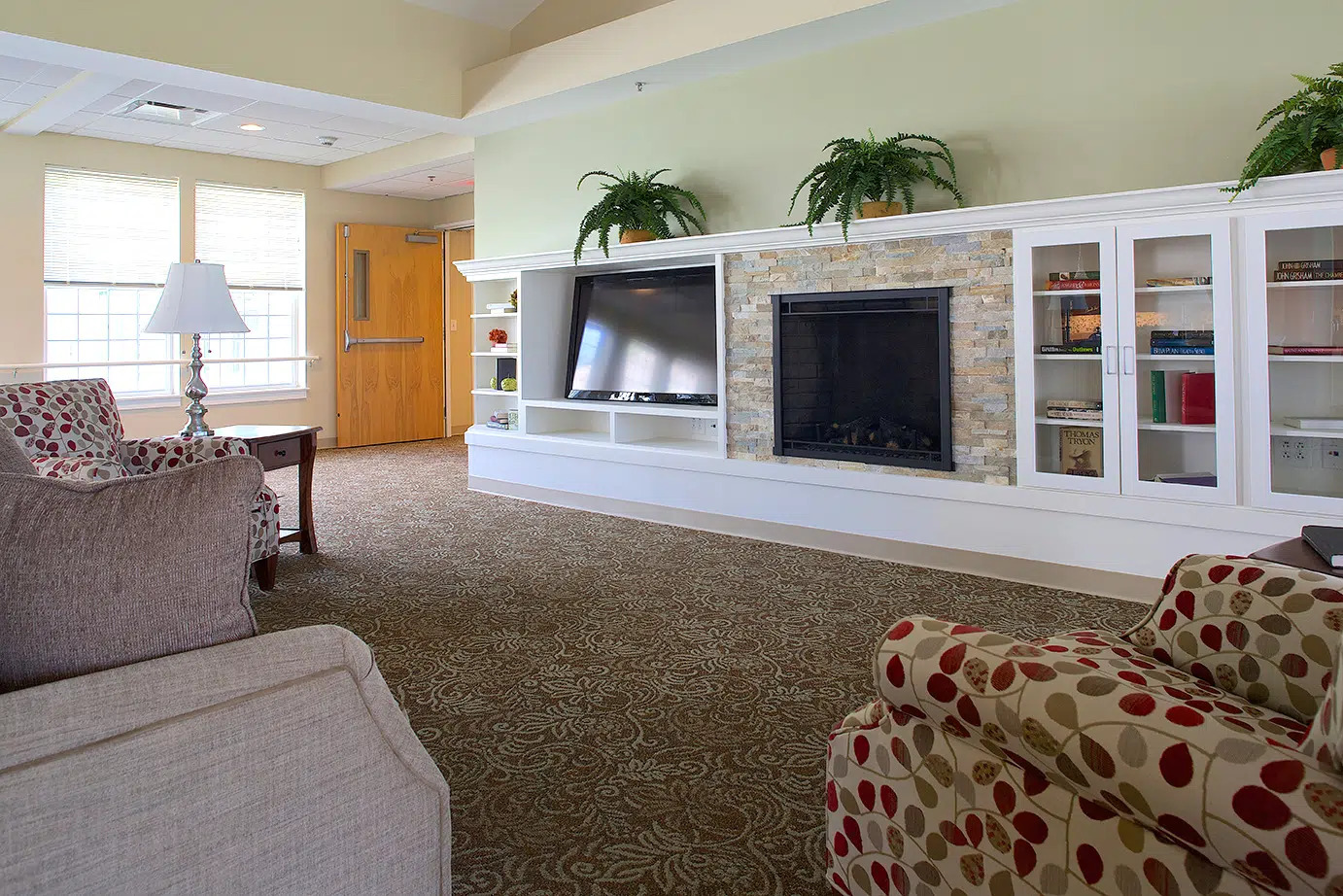The hearth room with a fireplace and armchairs