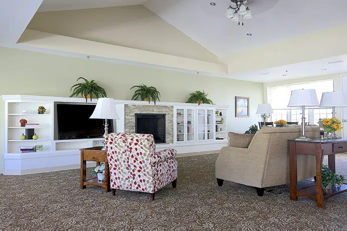 A living room with a television and armchairs
