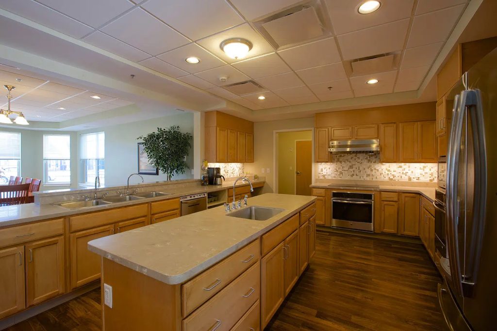 A kitchen with wood cabinets and stainless appliances