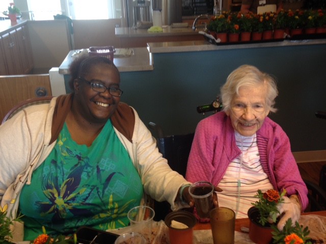 Two residents smiling during a gardening activity