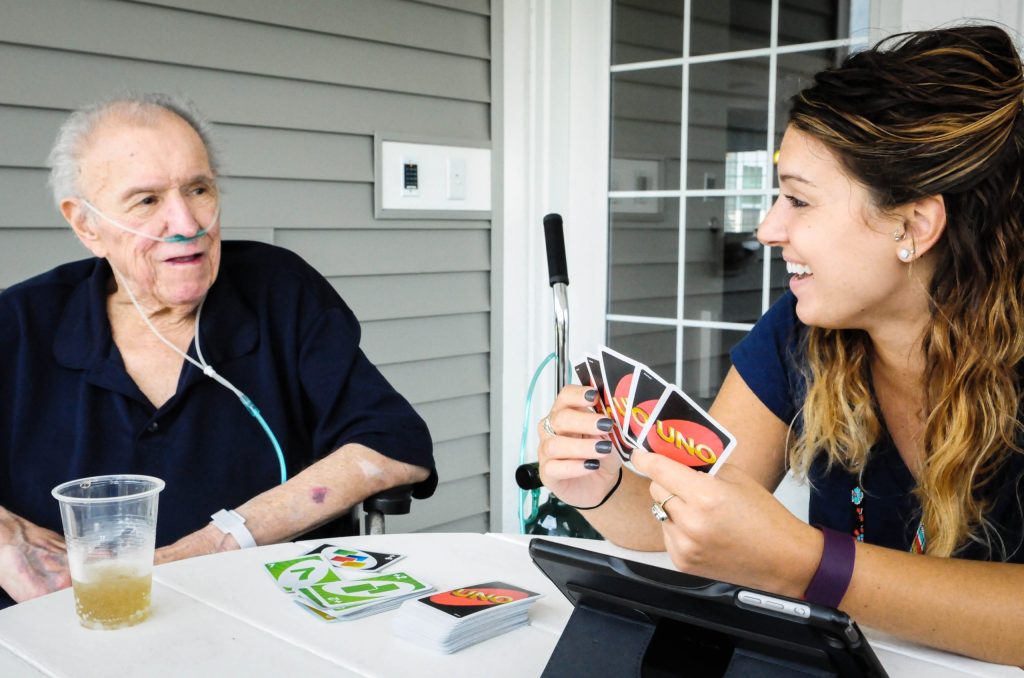 A therapist working with a resident at a table